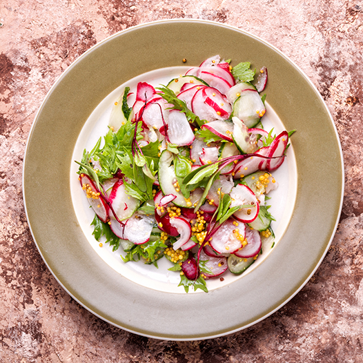 Spring radish salad with black cumin seed oil dressing